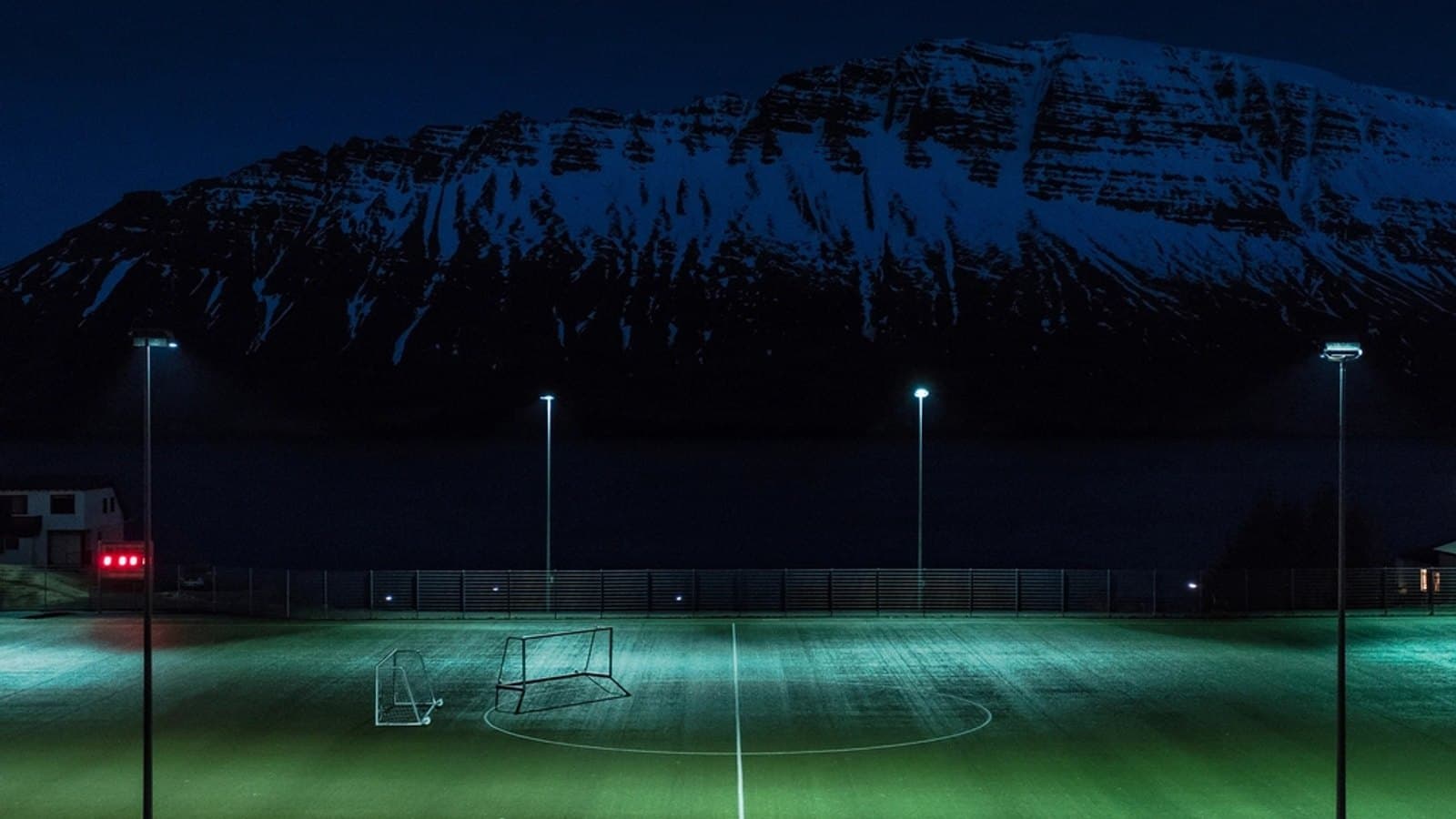 Turf soccer pitch illuminated floodlights. File photograph.