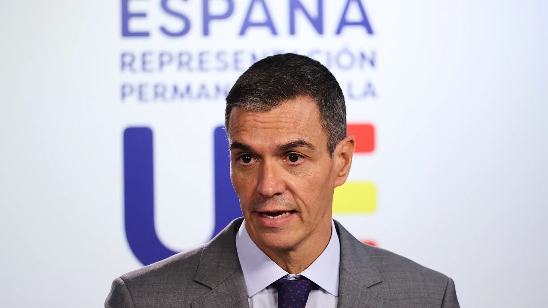 Pedro Sanchez speaks to reporters in front of the Spain and European Union logos